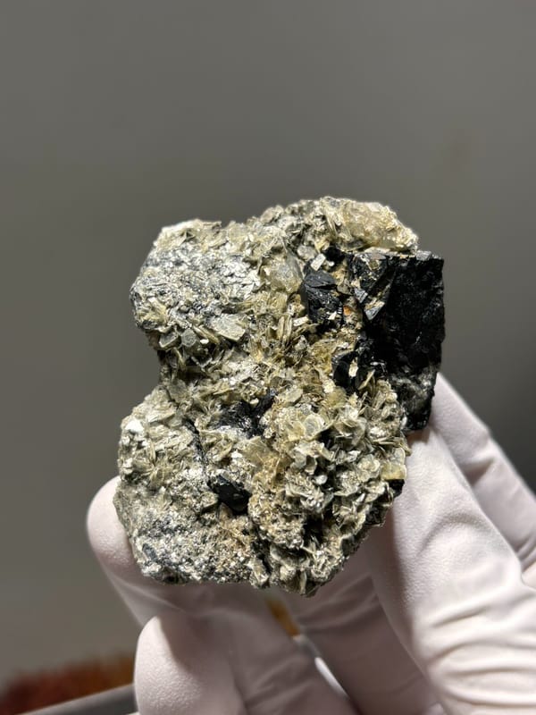 Black cassiterite crystals with aquamarine on mica from Xuebaoding, Sichuan, China, second angle
