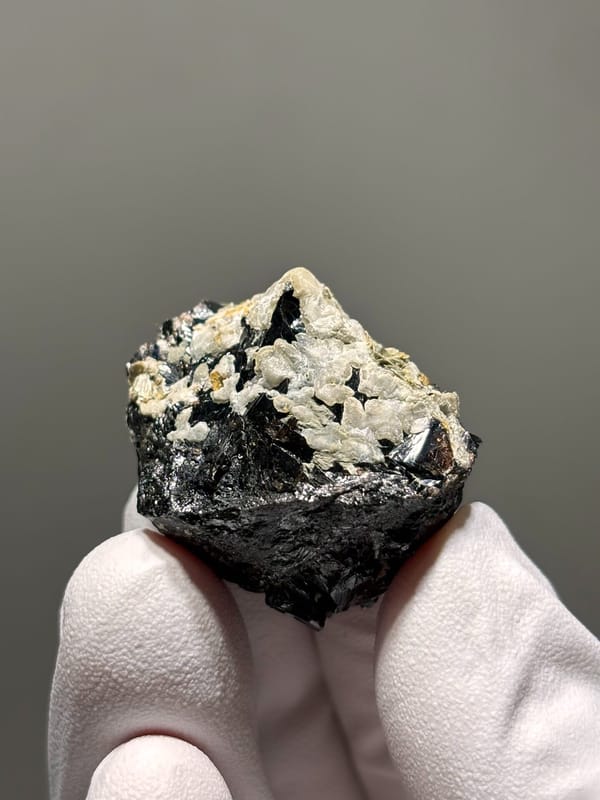 Black cassiterite with white calcite like a snow mountain from Xuebaoding, Sichuan, China, reverse side