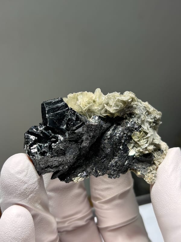 Black cassiterite plate with pale mica from Xuebaoding, Sichuan, China, second angle