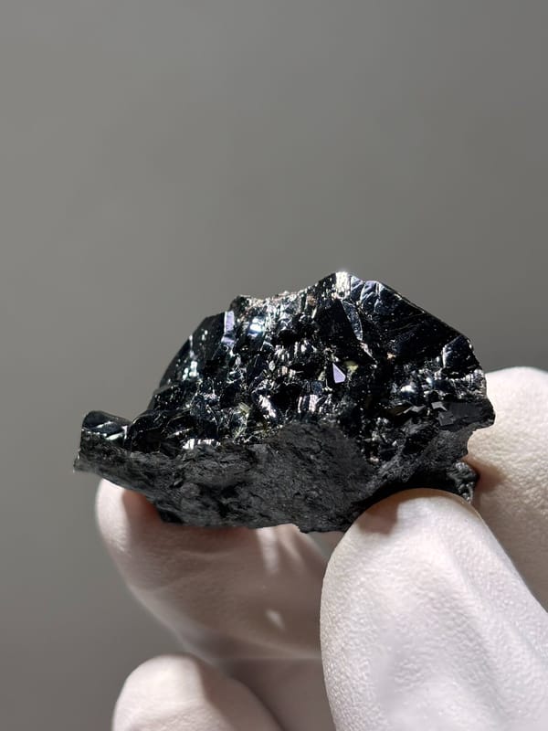 Black cassiterite crystal group from Xuebaoding, Sichuan, China, close-up of the crystal faces