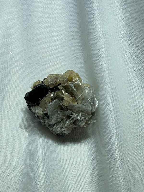 Black cassiterite with scheelite and mica from Xuebaoding, Sichuan, China, second angle