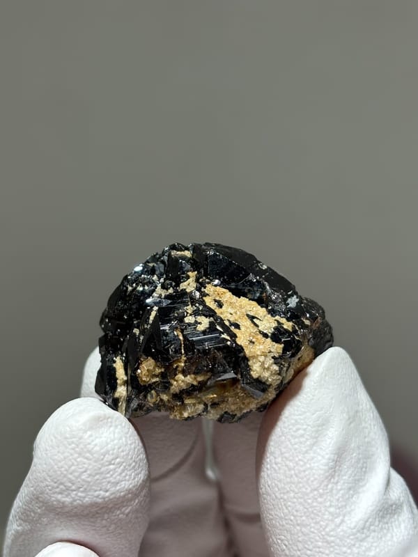 Glossy black cassiterite crystal from Xuebaoding, Sichuan, China, close-up of the crystal faces
