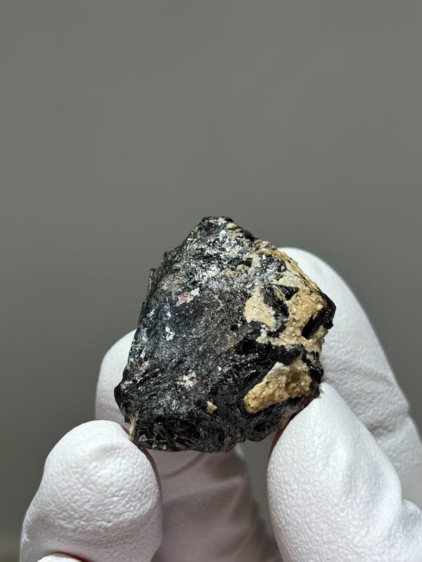 Glossy black cassiterite crystal from Xuebaoding, Sichuan, China, reverse side
