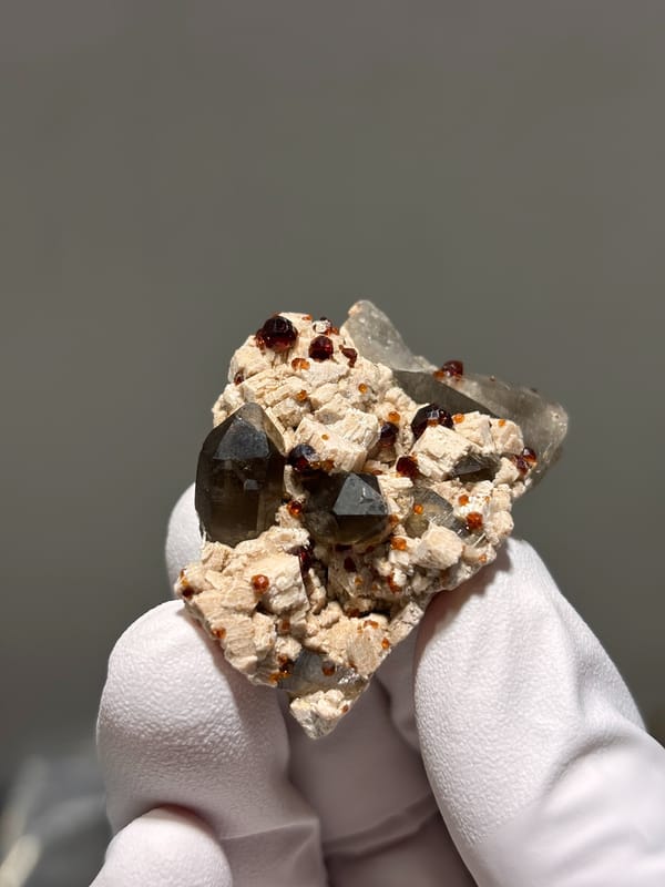Red garnets on feldspar with smoky quartz from Fujian, China, second angle