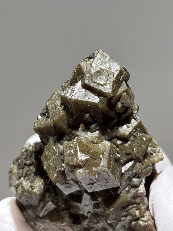 Olive-brown garnet crystal cluster from Inner Mongolia, China, close-up of the crystal faces