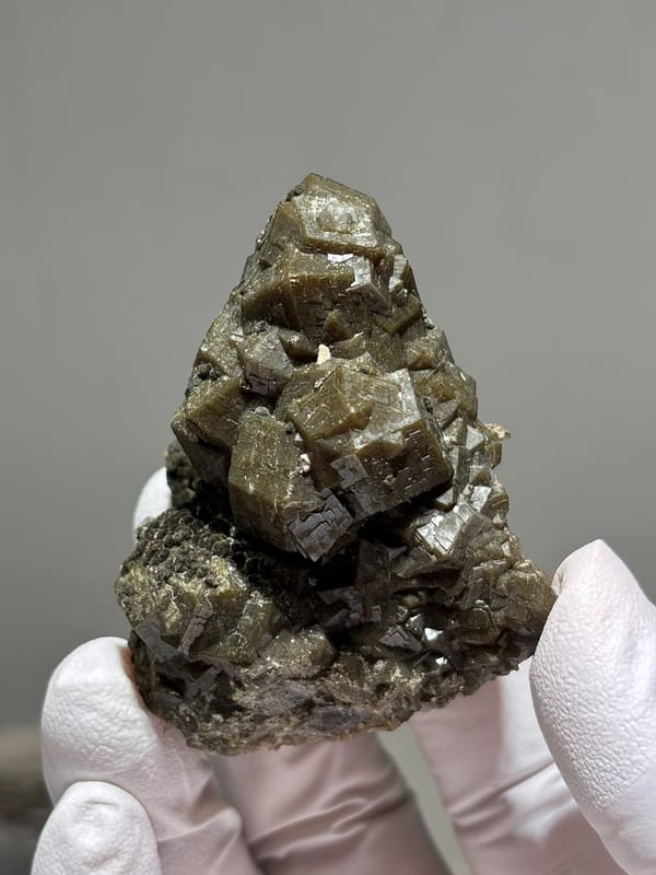 Olive-brown garnet crystal cluster from Inner Mongolia, China, detail of the matrix contact