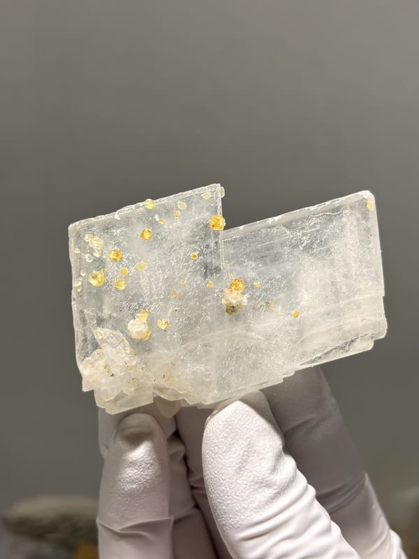 Clear baryte blade with yellow calcite specks from Sichuan, China, second angle