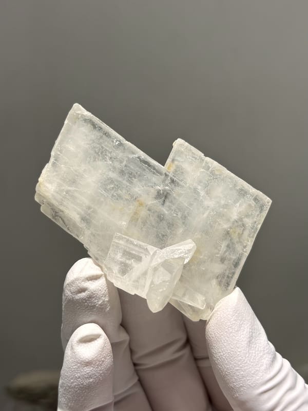 Clear baryte blade with yellow calcite specks from Sichuan, China, reverse side