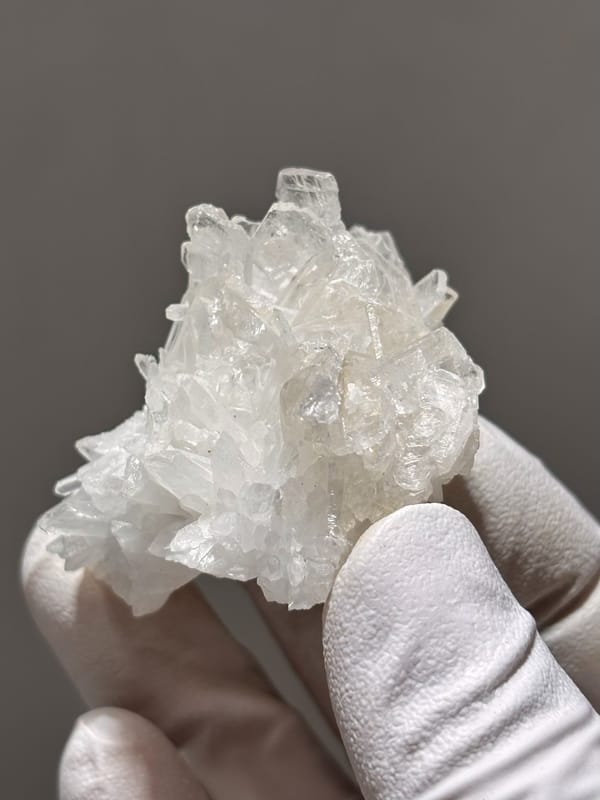 Cluster of clear baryte blades with quartz from Sichuan, China, close-up of the crystal faces