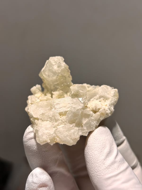 Cluster of cream baryte crystals with rising blade from Sichuan, China, close-up of the crystal faces