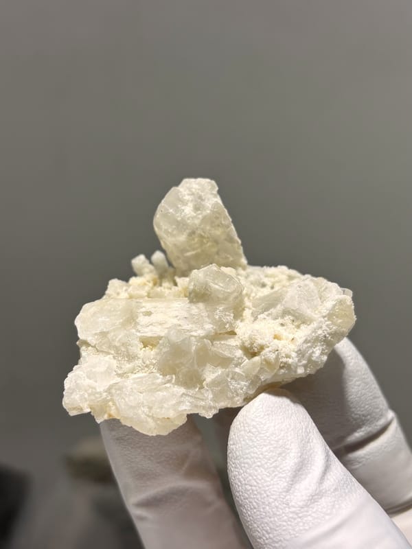 Cluster of cream baryte crystals with rising blade from Sichuan, China, reverse side