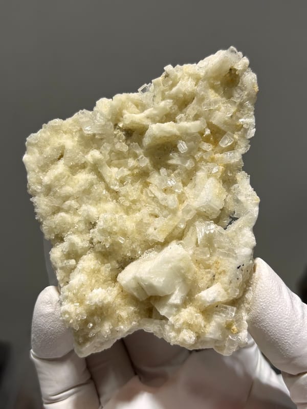 Plate of cream baryte in two crystal habits from Sichuan, China, close-up of the crystal faces