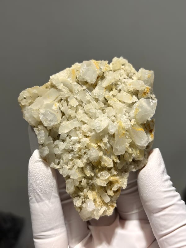 Plate of cream baryte crystals with golden staining from Sichuan, China, second angle
