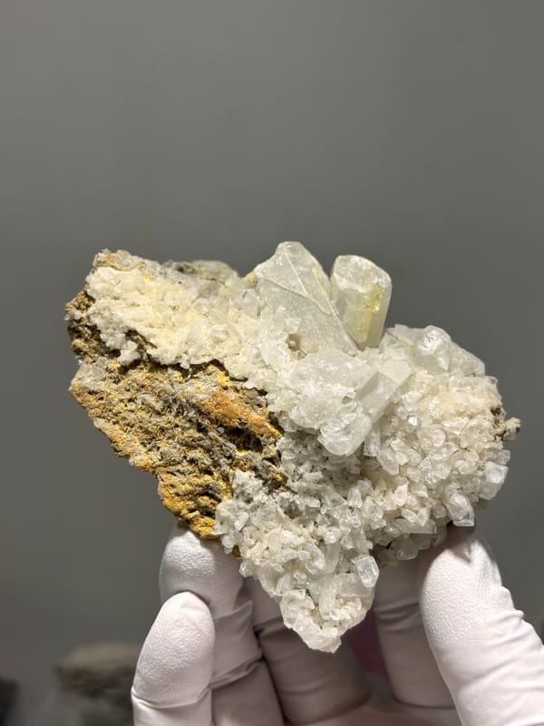 Plate of cream baryte crystals on golden matrix from Sichuan, China, second angle