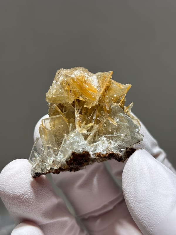 Golden-yellow baryte blades with pale blue tint from Hubei, China, close-up of the crystal faces