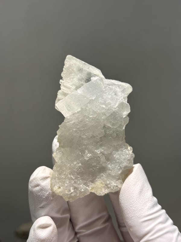 Pale etched baryte crystal group from Sichuan, China, close-up of the crystal faces