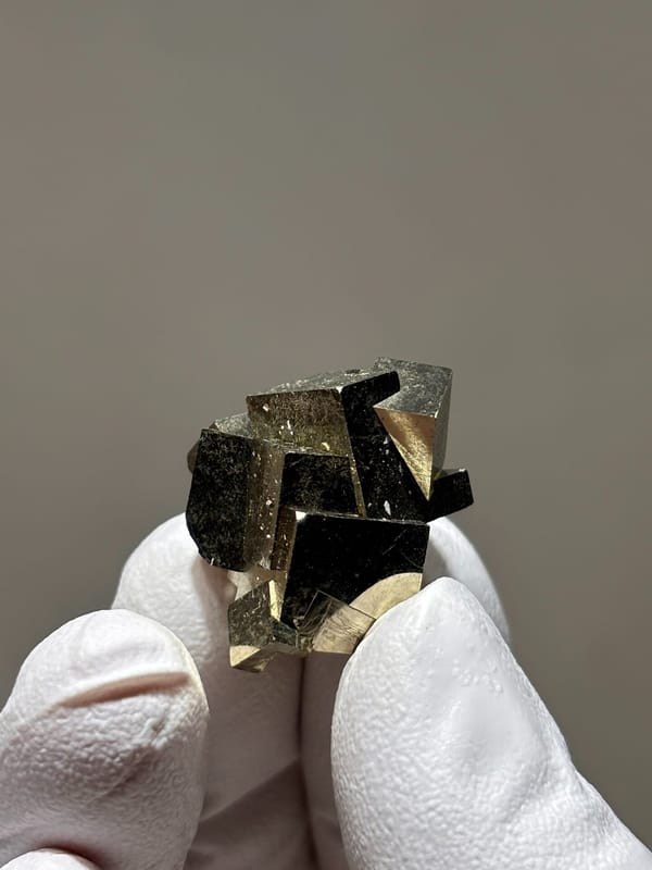 Tiny cluster of intergrown pyrite cubes from Hubei, China, second angle