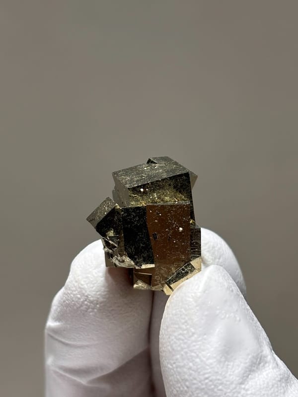 Tiny cluster of intergrown pyrite cubes from Hubei, China, close-up of the crystal faces