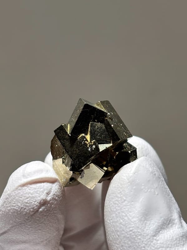 Tiny cluster of intergrown pyrite cubes from Hubei, China, reverse side