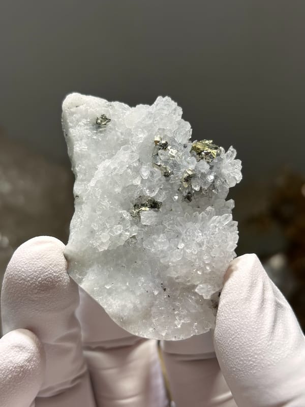 White quartz druse with pyrite and chalcopyrite from Jiangxi, China, close-up of the crystal faces