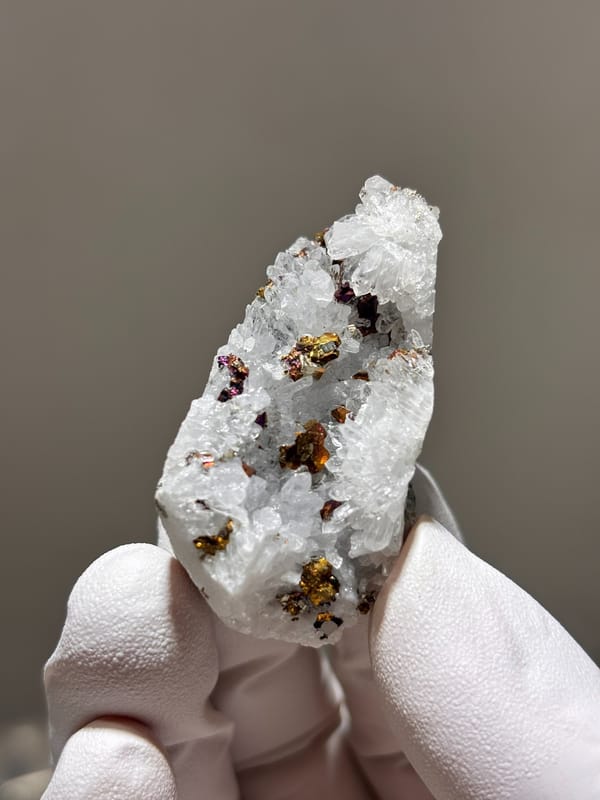 White quartz with iridescent pyrite from Hubei, China, close-up of the crystal faces