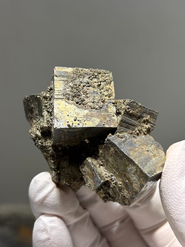 Cluster of pyrite cubes with mirror faces from Hubei, China, close-up of the crystal faces