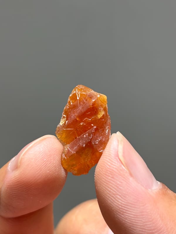 Tiny bright orange scheelite crystal from Xuebaoding, Sichuan, China, second angle