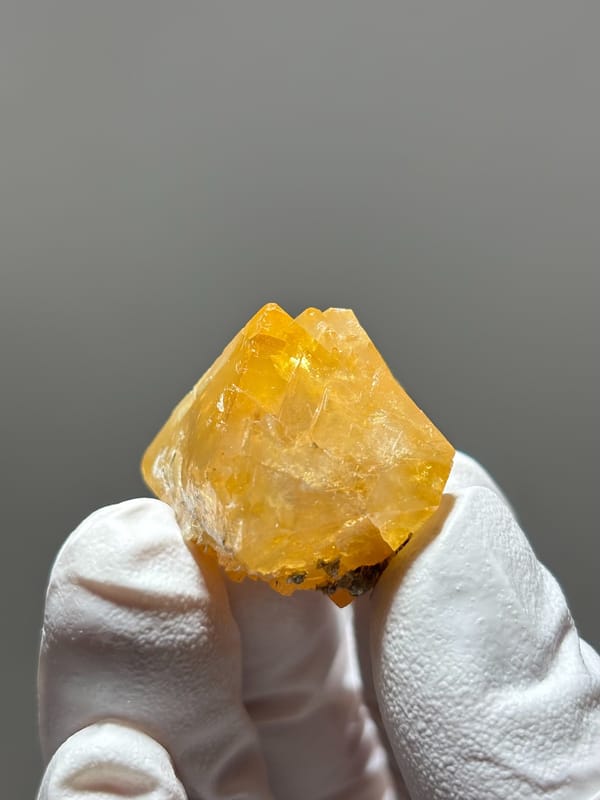 Bright orange scheelite floater crystal from Xuebaoding, Sichuan, China, reverse side