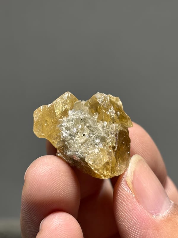Golden scheelite cluster with mica from Xuebaoding, Sichuan, China, close-up of the crystal faces