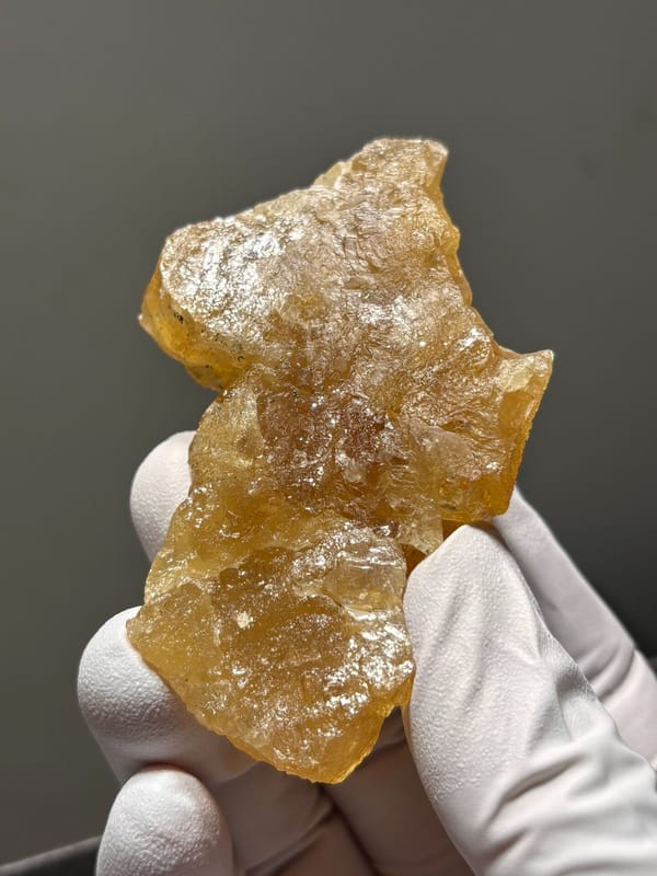 Golden scheelite crystal group from Xuebaoding, Sichuan, China, close-up of the crystal faces