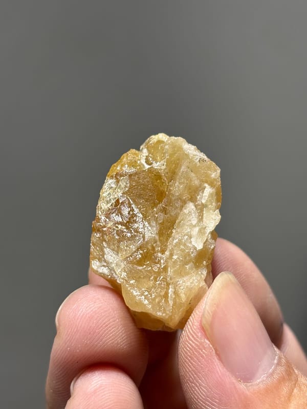 Golden-orange scheelite crystal from Xuebaoding, Sichuan, China, close-up of the crystal faces