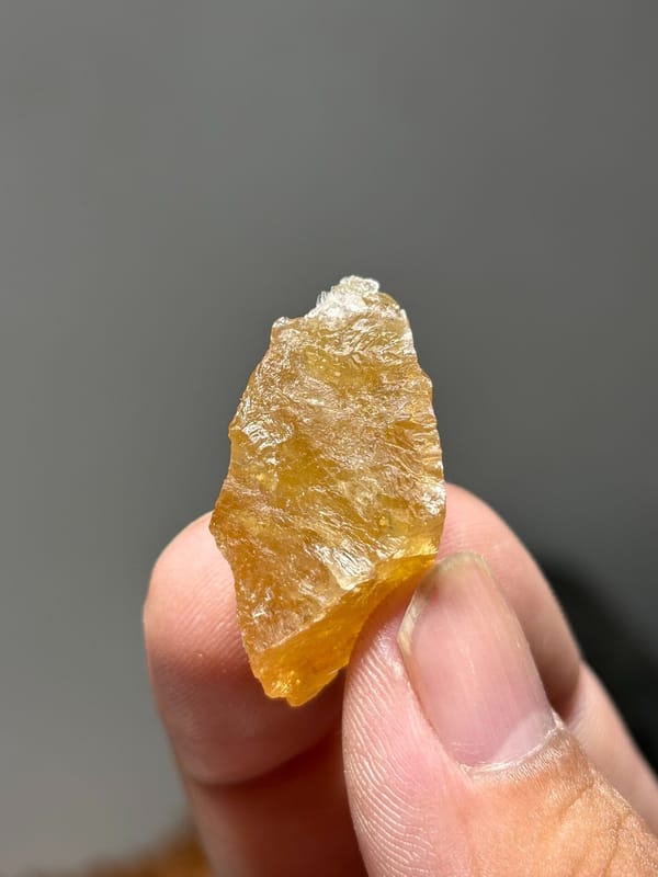 Golden-orange scheelite with floater faces from Xuebaoding, Sichuan, China, close-up of the crystal faces