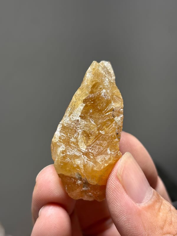 Golden-orange scheelite from Xuebaoding, Sichuan, China, close-up of the crystal faces