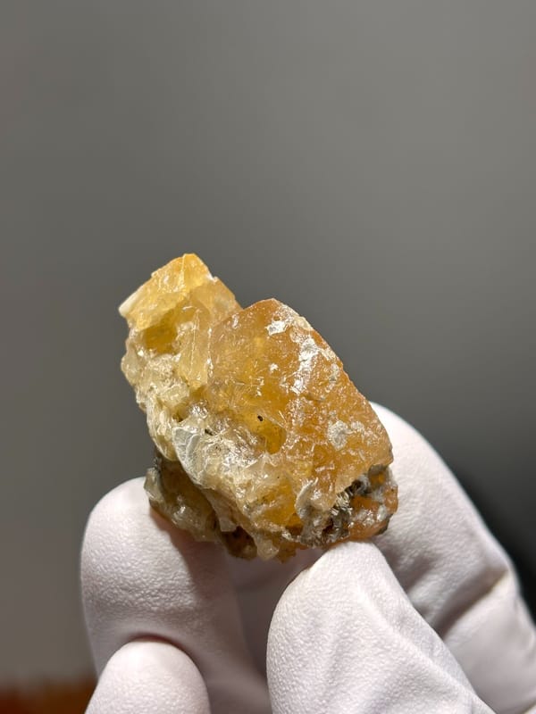 Golden-yellow scheelite crystal from Xuebaoding, Sichuan, China, close-up of the crystal faces