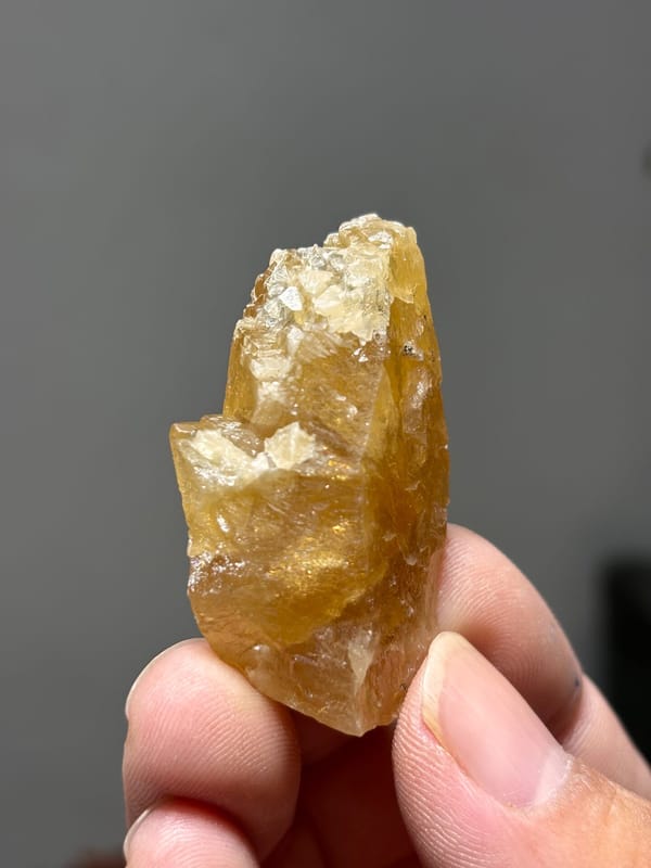 Golden-yellow scheelite crystal from Xuebaoding, Sichuan, China, close-up of the crystal faces