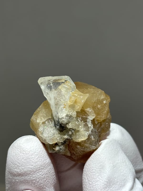Honey scheelite with small clear aquamarine from Xuebaoding, Sichuan, China, reverse side