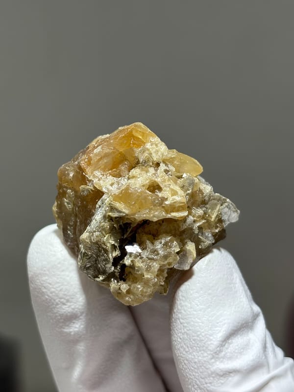 Honey scheelite with clear fluorite from Xuebaoding, Sichuan, China, reverse side