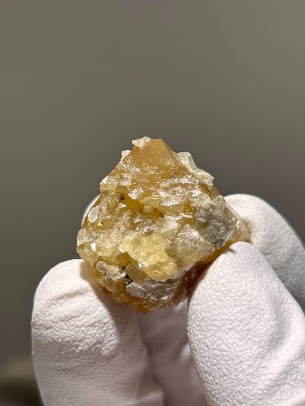 Honey scheelite with white mica flakes from Xuebaoding, Sichuan, China, reverse side
