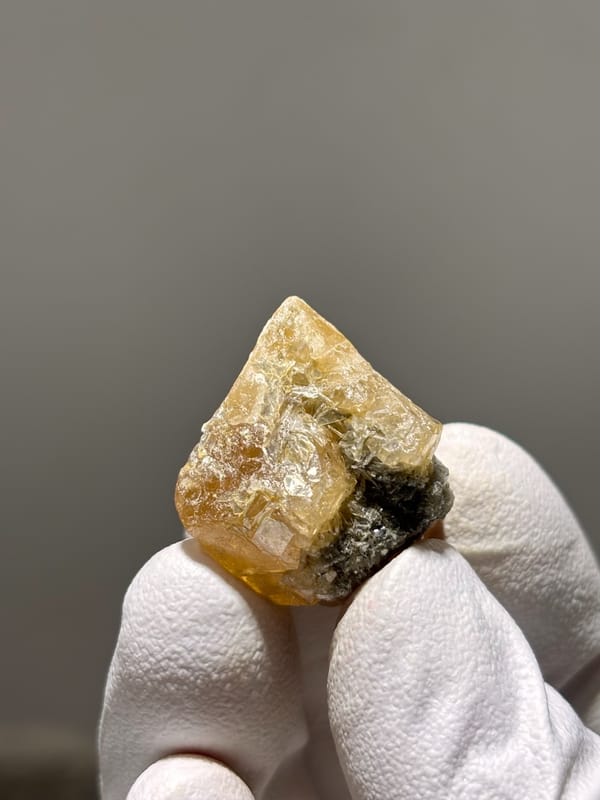 Honey scheelite crystal with mica from Xuebaoding, Sichuan, China, close-up of the crystal faces