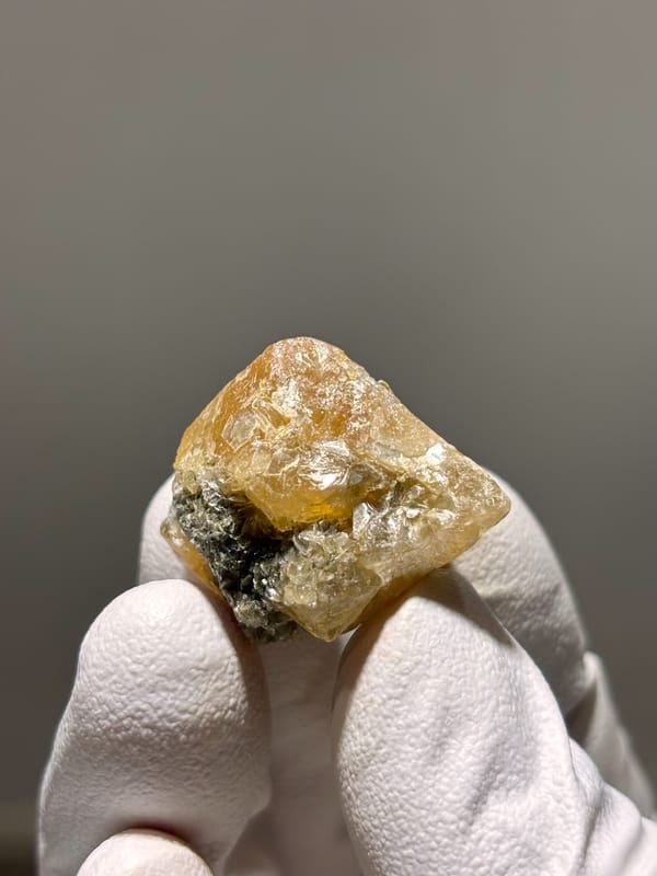 Honey scheelite crystal with mica from Xuebaoding, Sichuan, China, reverse side