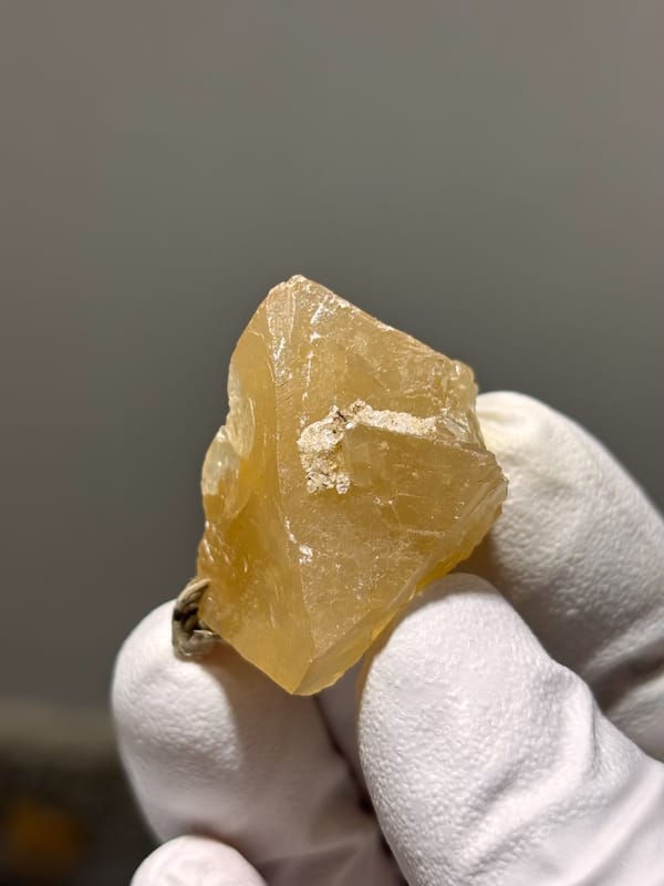 Honey scheelite with mica fleck from Xuebaoding, Sichuan, China, close-up of the crystal faces