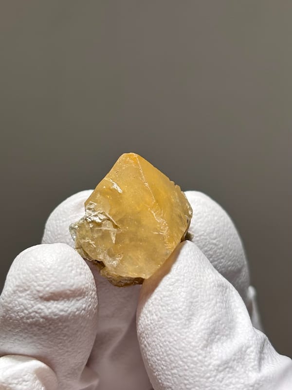 Small honey scheelite on mica from Xuebaoding, Sichuan, China, second angle