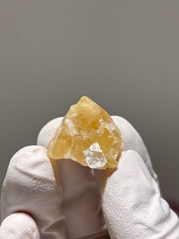 Small honey scheelite crystal with mica from Xuebaoding, Sichuan, China, reverse side