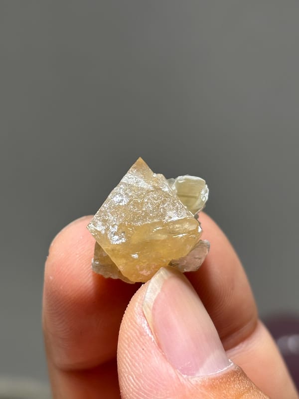 Small honey scheelite with mica from Xuebaoding, Sichuan, China, second angle