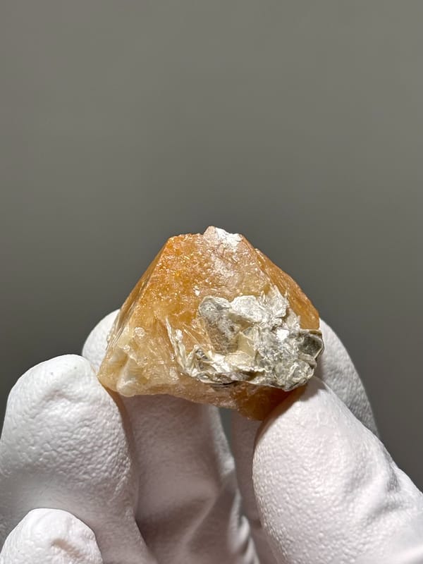 Honey scheelite crystal with mica cap from Xuebaoding, Sichuan, China, second angle