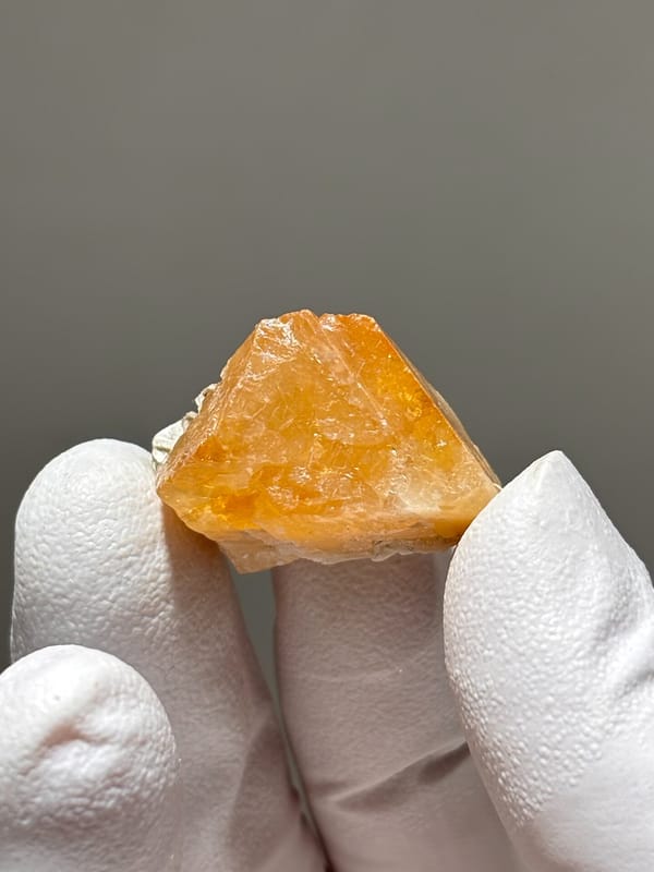 Honey scheelite crystal with mica cap from Xuebaoding, Sichuan, China, close-up of the crystal faces