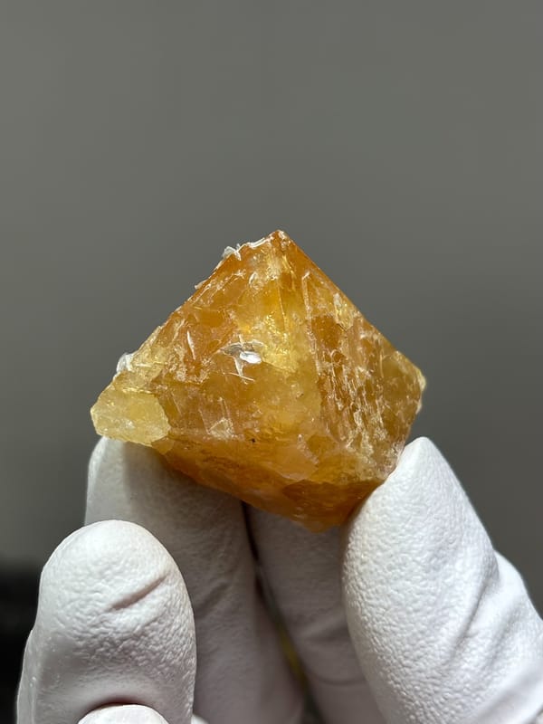 Honey scheelite with mica flakes on its faces from Xuebaoding, Sichuan, China, second angle