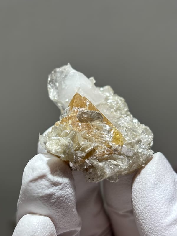 Honey scheelite with clear quartz point and mica from Xuebaoding, Sichuan, China, second angle