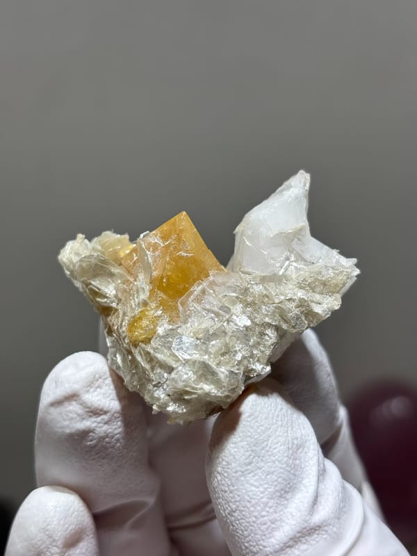 Honey scheelite with clear quartz point and mica from Xuebaoding, Sichuan, China, reverse side