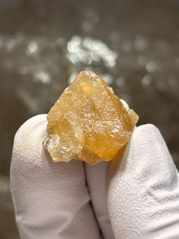 Small honey scheelite crystal from Xuebaoding, Sichuan, China, reverse side